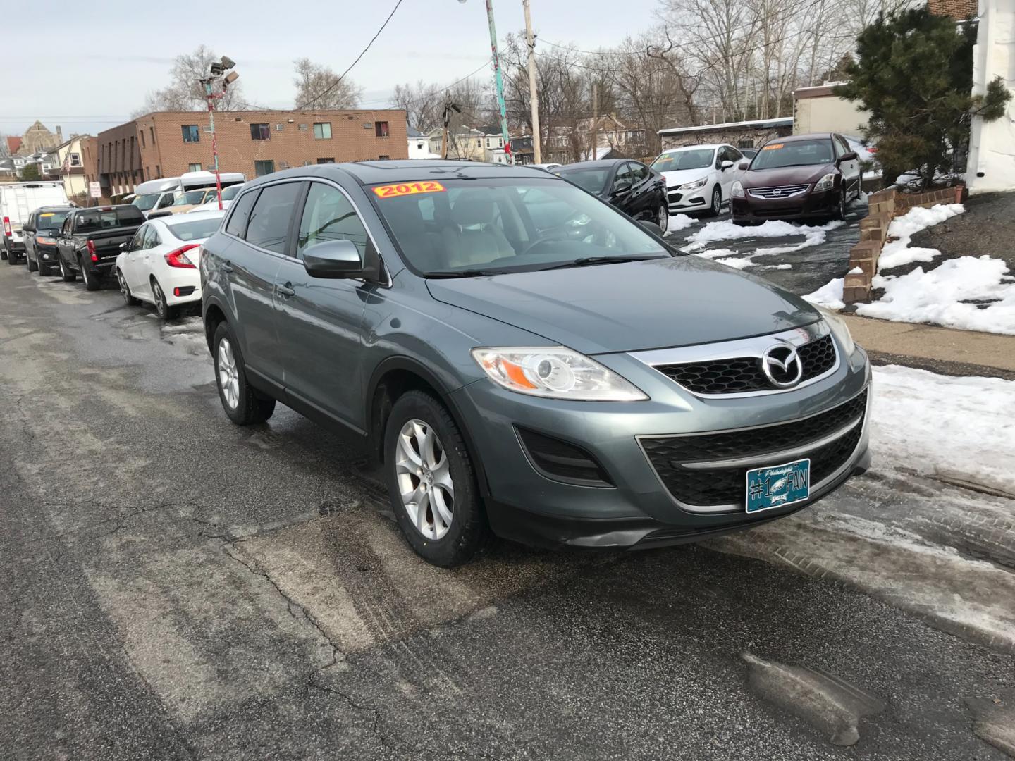 2012 Green /Tan Mazda CX-9 Sport (JM3TB3BV4C0) with an 3.7 V6 engine, Automatic transmission, located at 577 Chester Pike, Prospect Park, PA, 19076, (610) 237-1015, 39.886154, -75.302338 - Photo#2